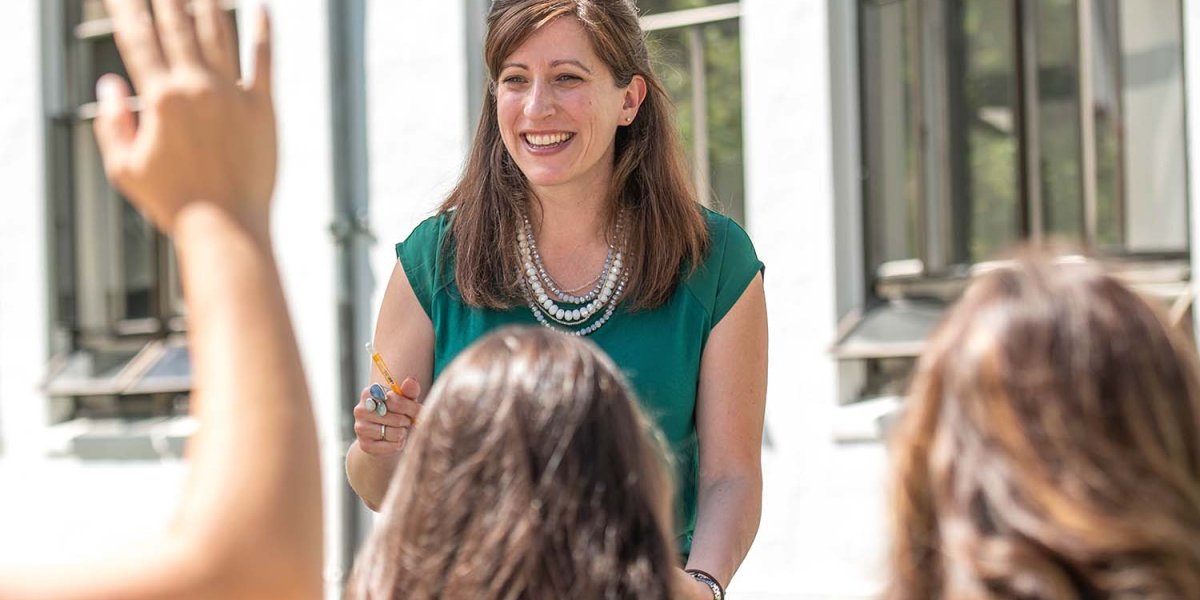 teacher laughs during outdoor class