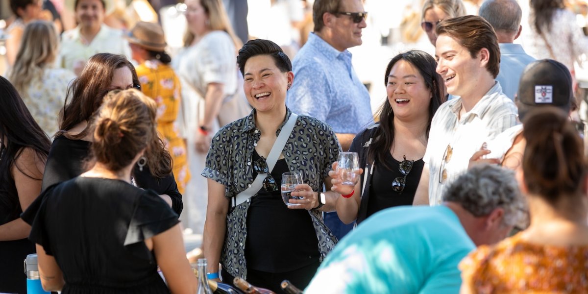 Guests laugh with hosts at the Summer Wine & Beer Fest