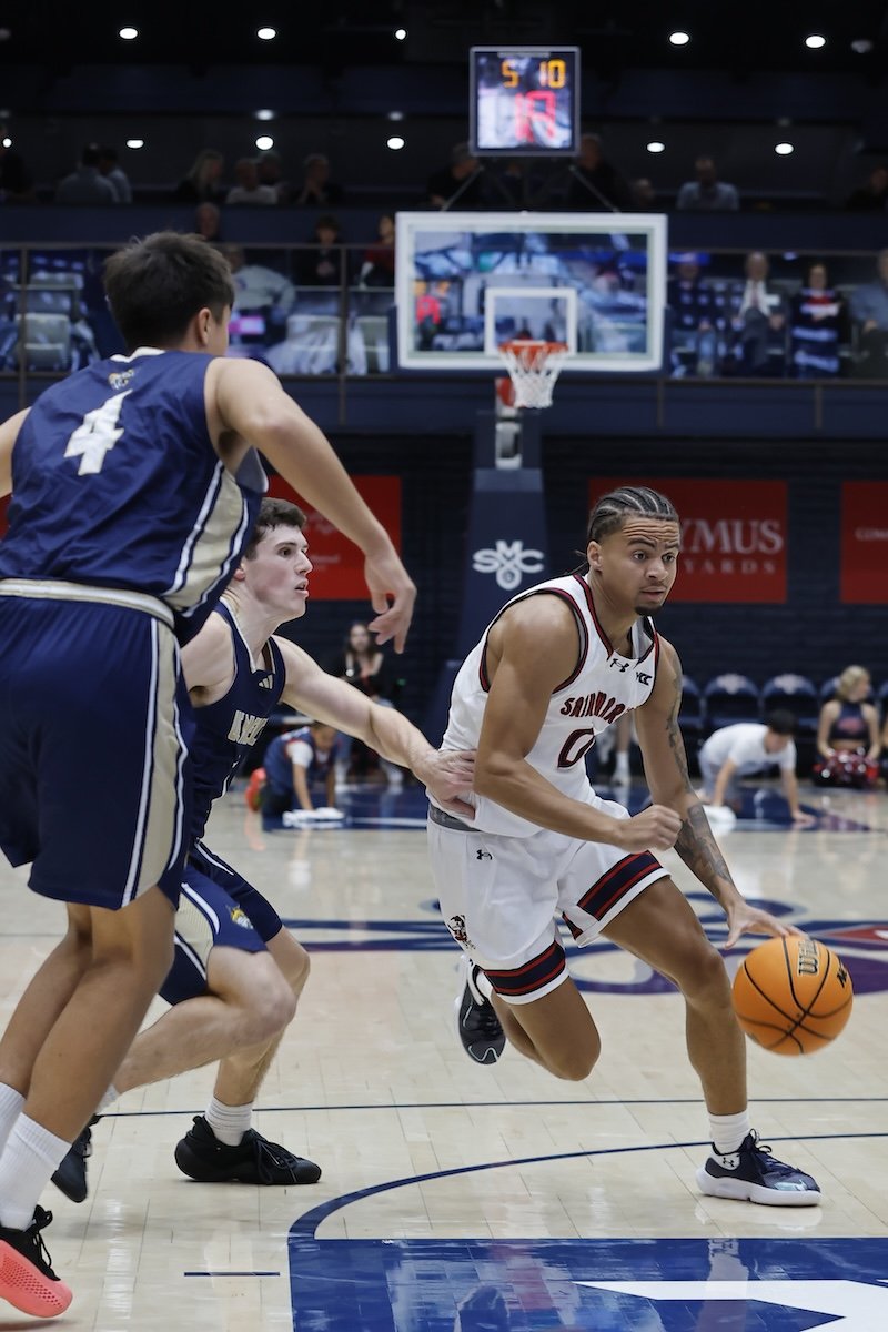 Men's basketball player Mikey Lewis drives against UC Merced in November 2025