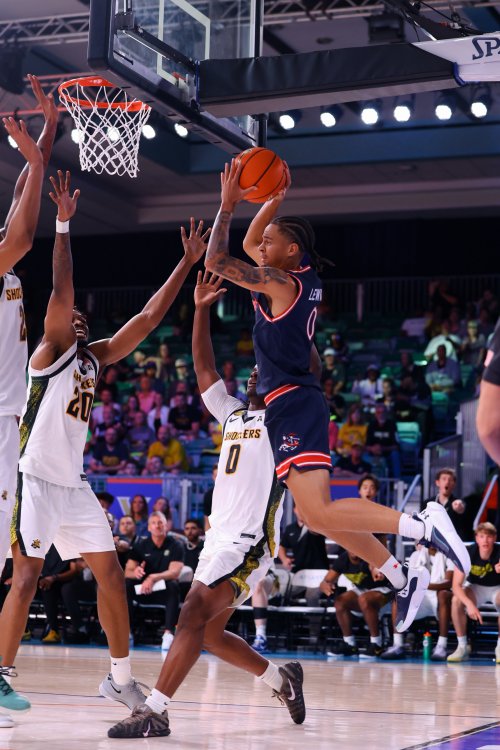 basketball player Mikey Lewis shoots against Wichita State in November 2025