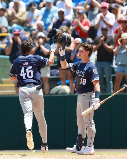 Baseball players Jacob Johnson and Ian Josephson tap helmets in in 2026 NCAA Regional