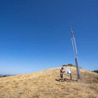 A student doing research atthe top of a hill