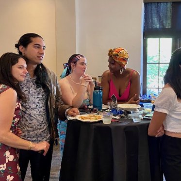 group of people standing around a table