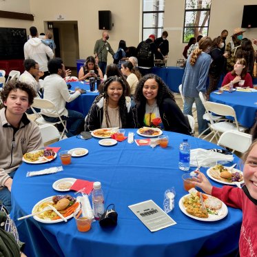 group of people sitting around the table and dinning