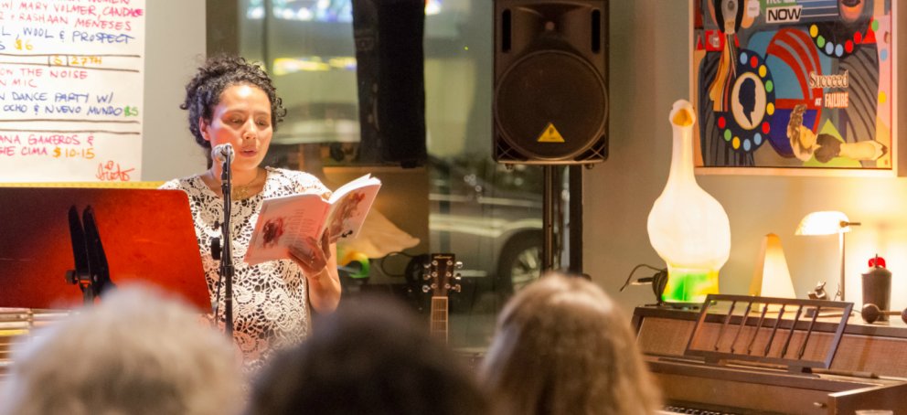 A writer performs her work on stage.