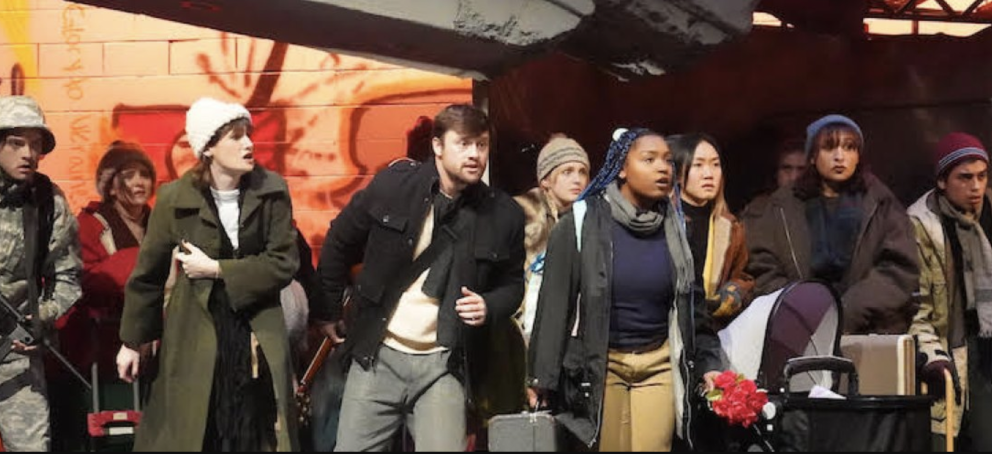 The Caucasian Chalk Circle performance with a crowd of refugees in front of a soldier