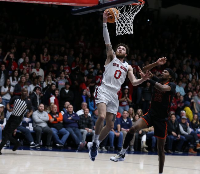 Men's Basketball player Logan Johnson scores against Pacific