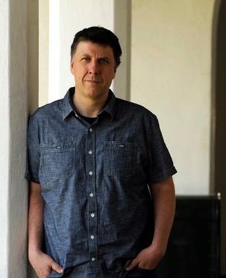 Photo of Professor Matthew Zapruder leaving against a white pillar