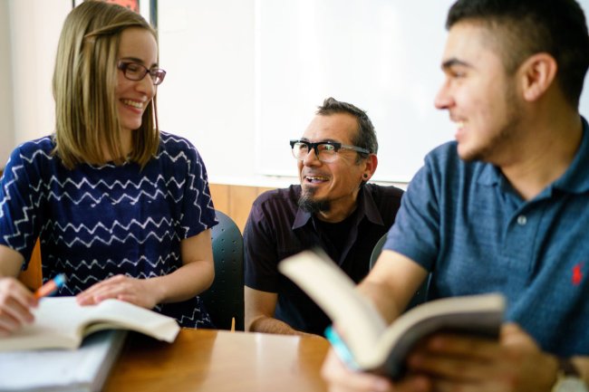 Students in class talking to a professor