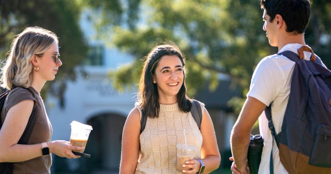 saint mary's students chatting outside with drink after a marketing minor class