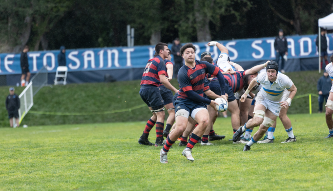 Ethan Taufa looks to pass the rugby ball