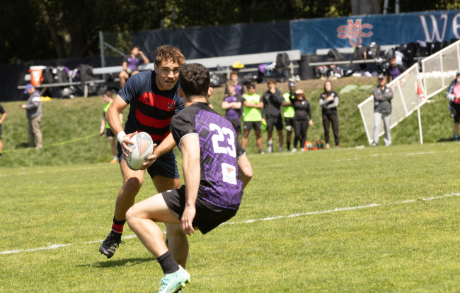 Ethan Younger carries the rugby ball