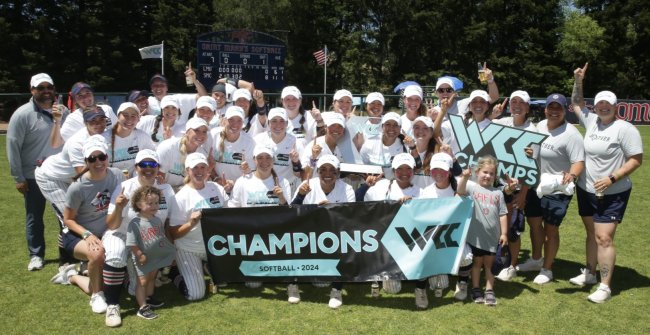 Saint Mary's softball team holding the WCC champions banner up