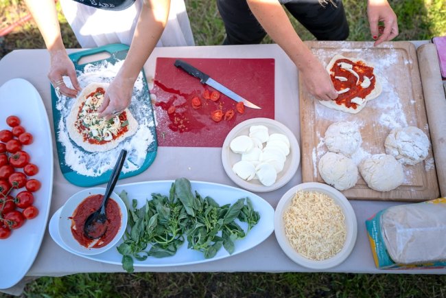 Students making pizza in the Legacy Garden on Earth Day 2024