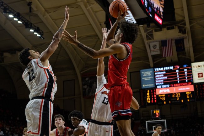 Men's basketball player Mikey Lewis shoots against OSU in February 2025