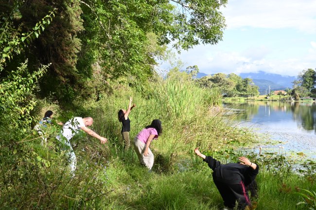Barragan leading movement exercises by lake in Colombia