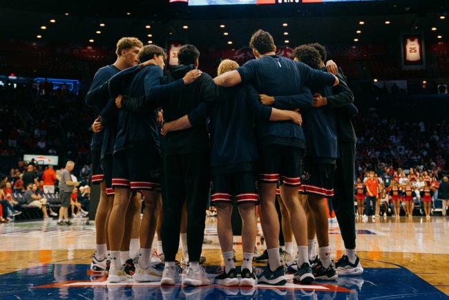 Gaels Men's Basketball team huddles before match against Arizona in 2025