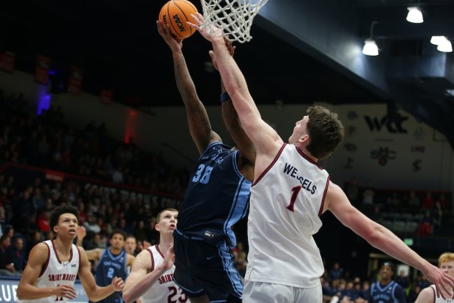 Basketball player Harry Wessels tries to block a shot against San Diego in February 2026