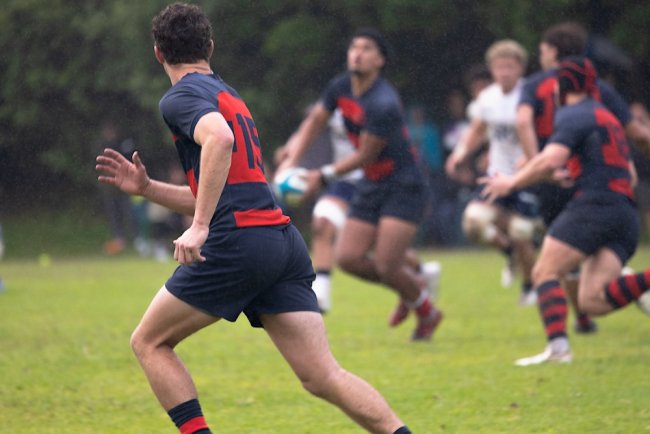 Men's Rugby players running and passing the ball in New Zealand in January 2026