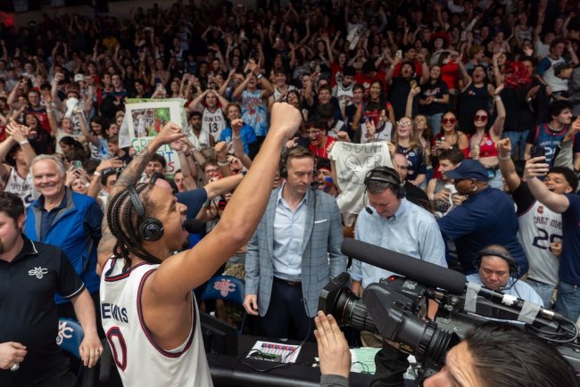 Basketball player Mikey Lewis cheers for fans after winning WCC Title in February 2026