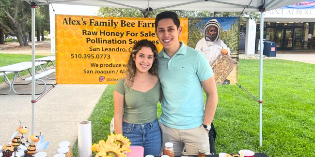 Alejandra Perez and Isaac Serrano Torres selling honey at Gideon Market