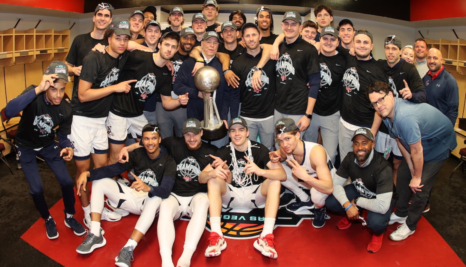 Men's basketball team celebrates on red carpet after winning WCC Championship 2024