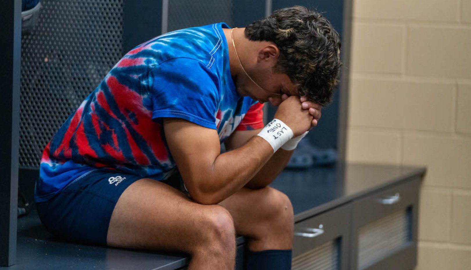 A Gaels men's rugby player in contemplation in the locker room before 2024 National Championships