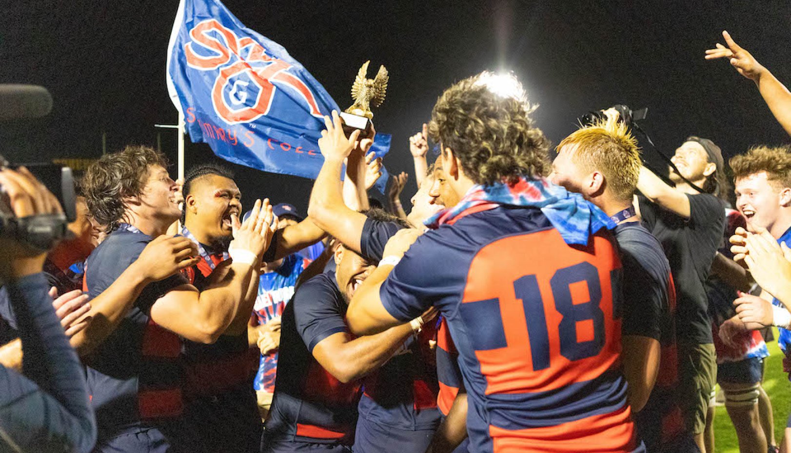 Saint Mary's men's rugby team waves SMC flag and celebrates winning 2024 National Championship