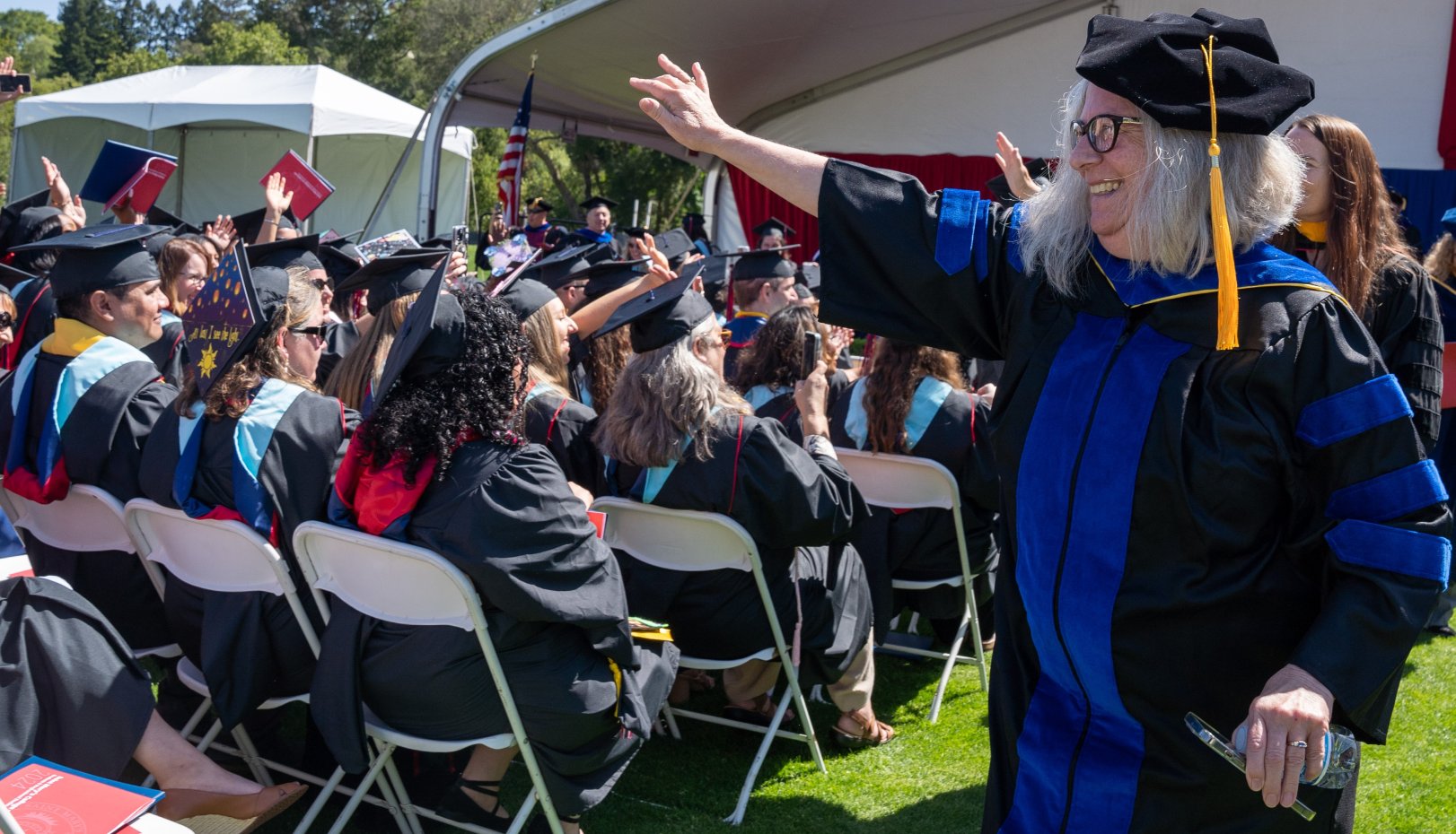 Faculty member waving