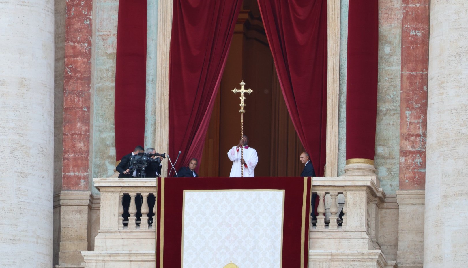 man with a cross on the balcony at St. Peter's in Rome in may 2025