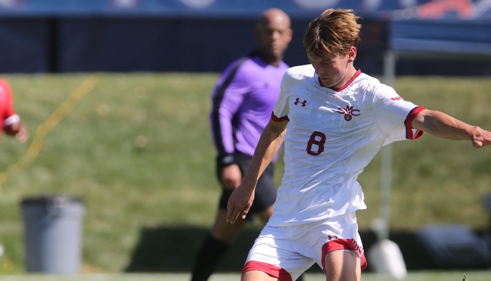 Men's Soccer player kicks a ball