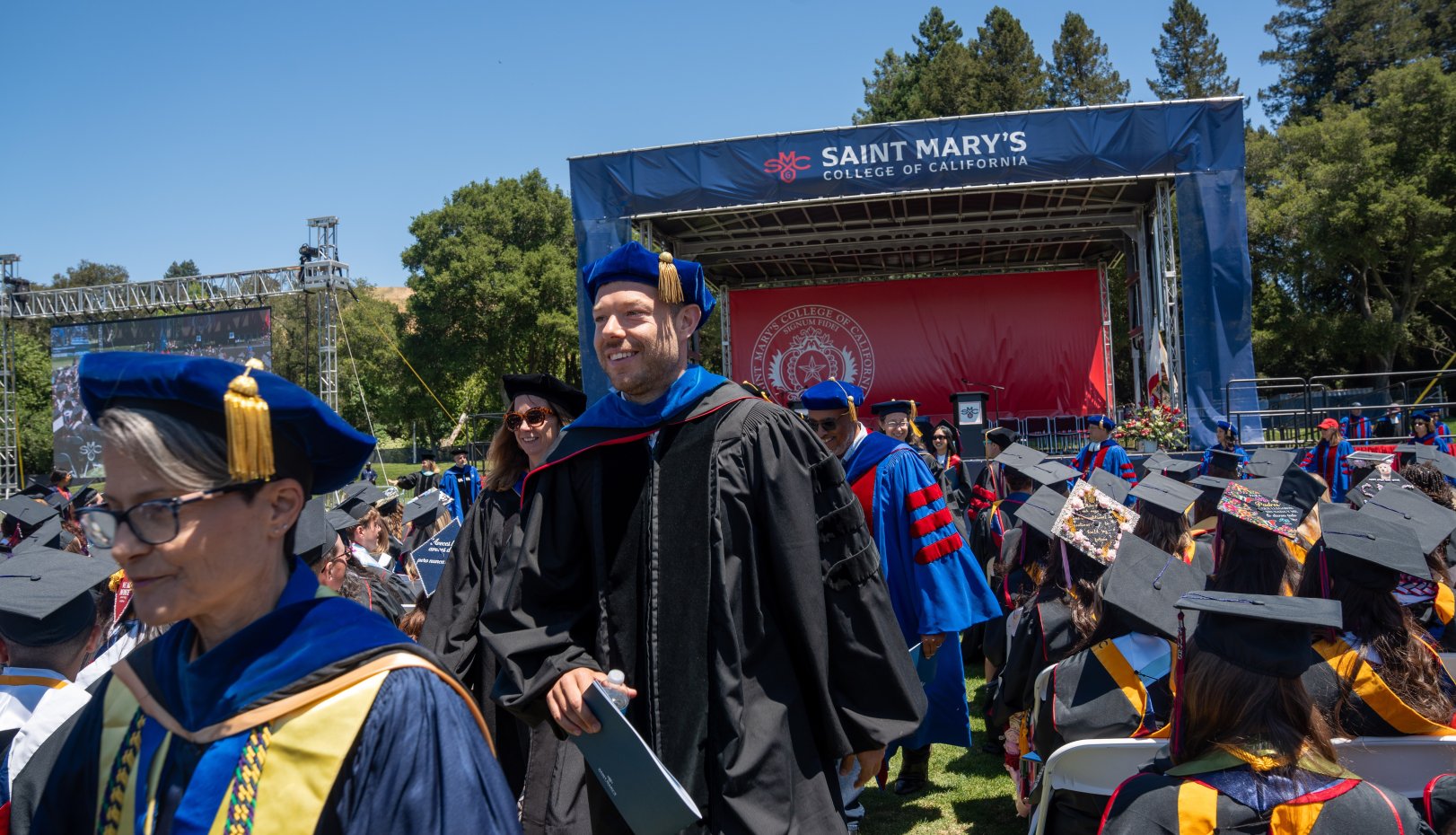 Matthew Dellavedova exiting Commencement stage