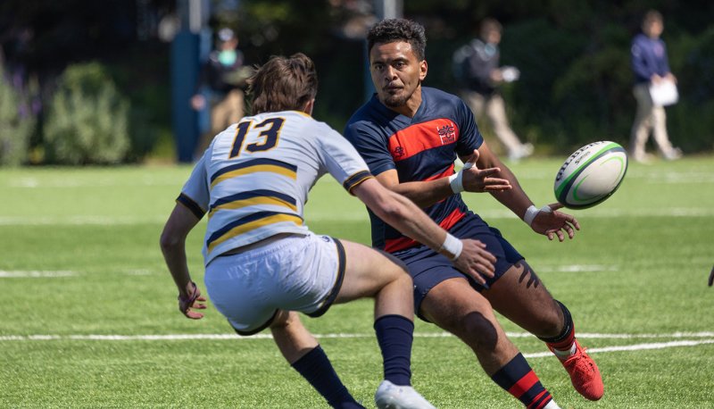 Saint Mary's Men's Rugby player Inoke Waqavesi runs past a UC Berkeley player on March 25, 2023