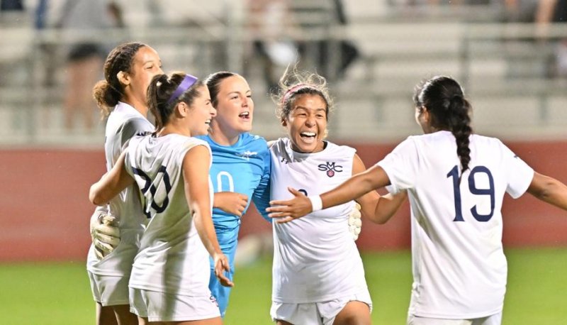 Five SMC women's soccer players celebrate in September 2023