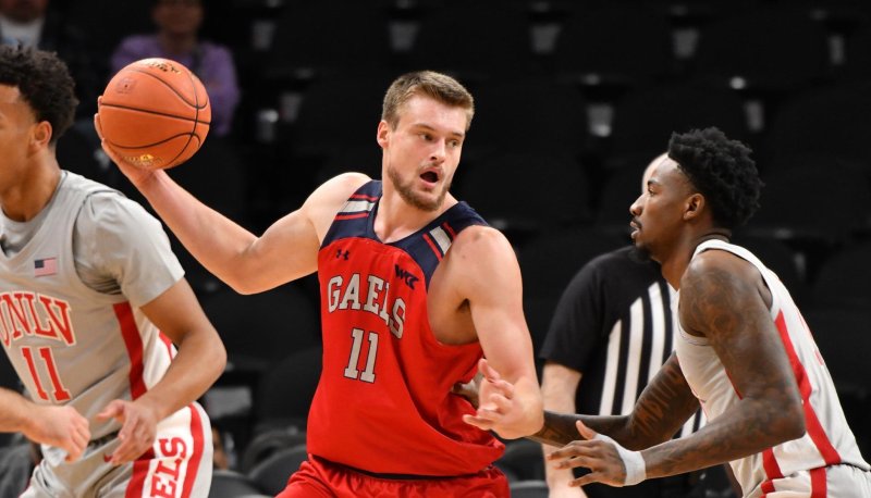 Men's basketball player Mitchell Saxen drives against UNLV in December 2023