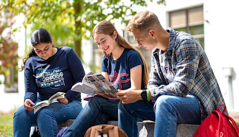 Students standing together in a group smiling on Saint Mary's College Campus