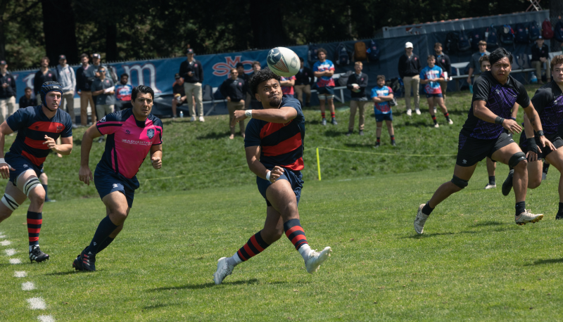 Inoke Waquavesi sends the Spiraling pass to his Rugby teammate