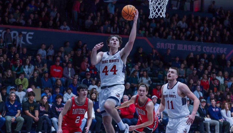 Men's Basketball player Alex Docas, No. 44, goes up for a basket against Davidson in November 2023