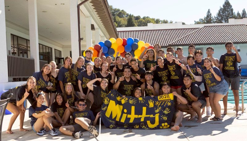 Residents of Mitty Hall posing by pool after winning 2024 First Year Olympics