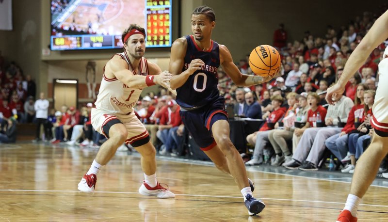Men's Basketball Player Mikey Lewis drives against Nebraska on November 17, 2024