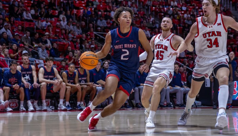 Men's Basketball player Jordan Ross drives against Utah in December 2024