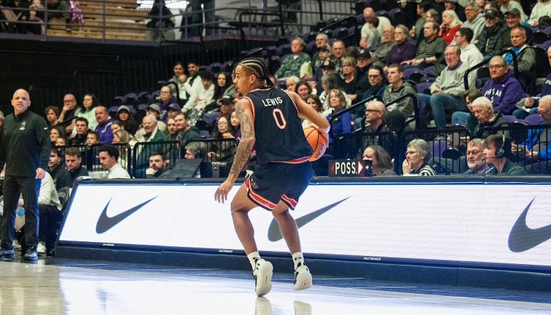 Basketball player Mikey Lewis drives against Portland in January 2026