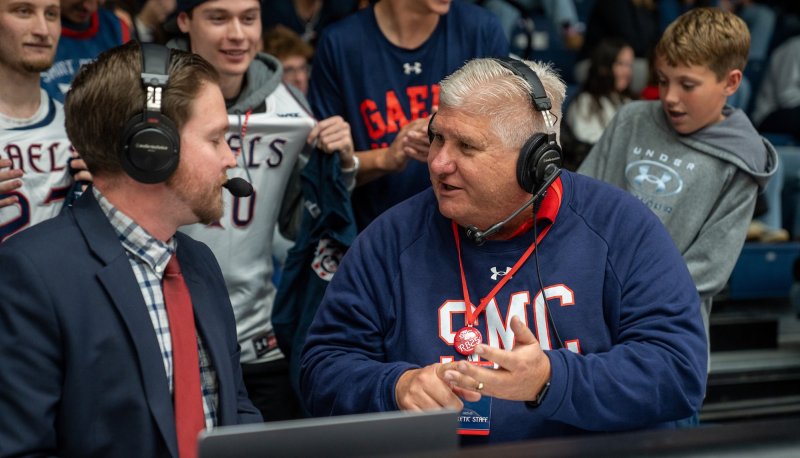 SMC President Roger Thompson talks with ESPN+ commentator Brian Brownfield at a Veterans Day Basketball Game