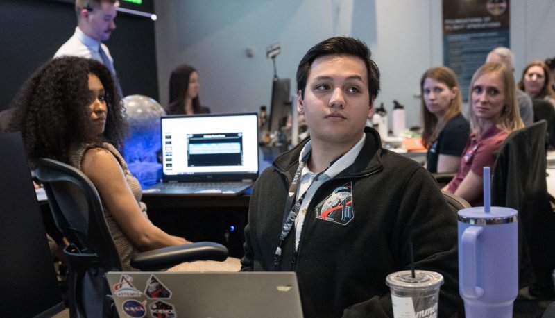 Jared Ralleta at his desk in Mission Control