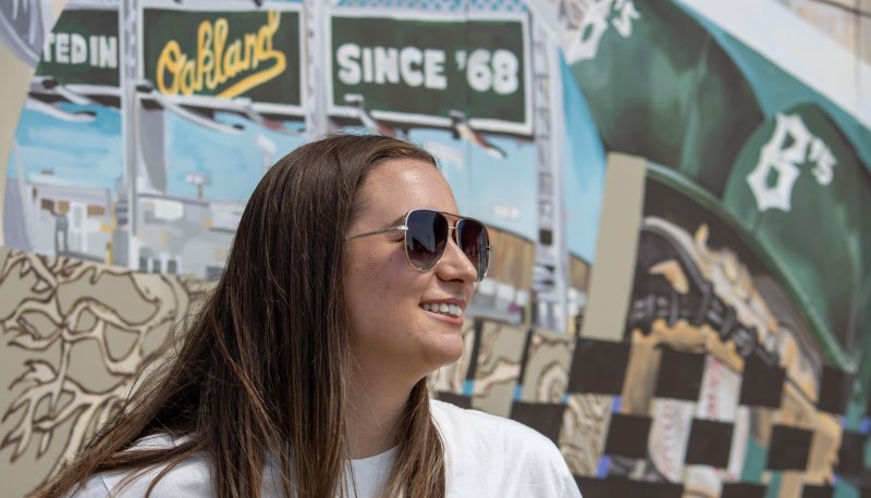 Mia Franceschi poses by Ballers mural at Raimondi Stadium