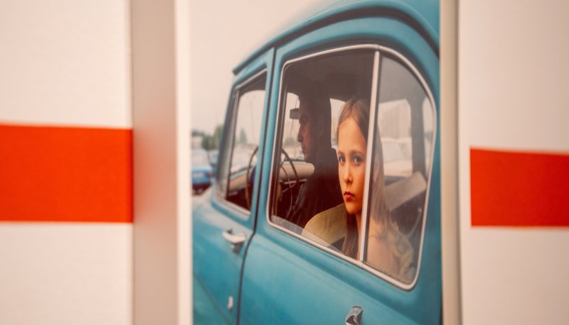 Ukrainian girl looking out back window of a car
