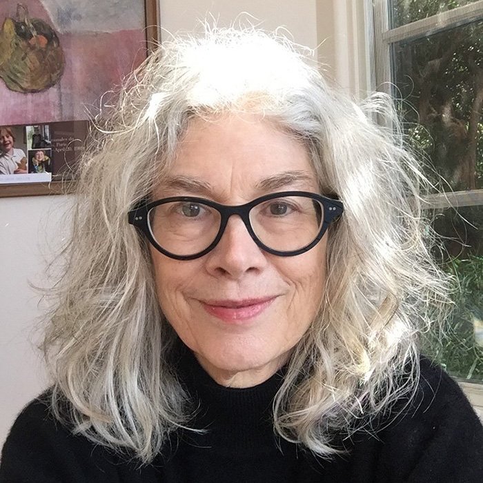 Headshot photo of Prof. Brenda Hillman in front of a window