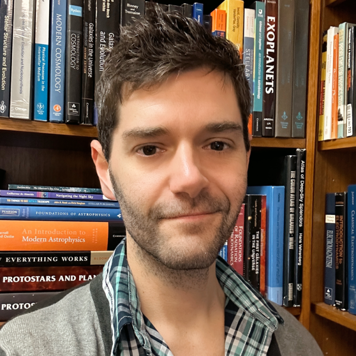 Professor Aaron Lee standing in front of a bookshelf