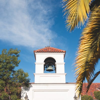 chapel in front of blue sky and foliage
