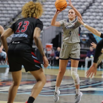 Taycee Wedin shoots a 3-pointer while teammate Leia Hanafin looks on.